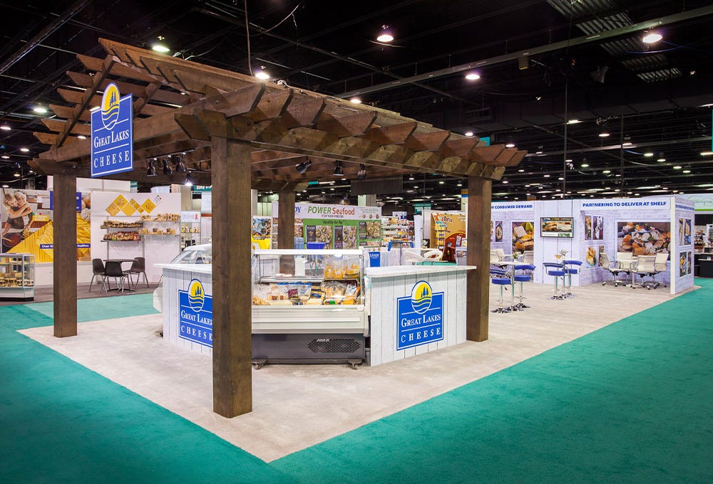 Unique Custom Island trade show booth with wooden structure and private meeting spaces