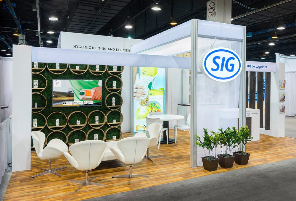 Modern style custom trade show booth with clean visuals and integrated grass turf wall