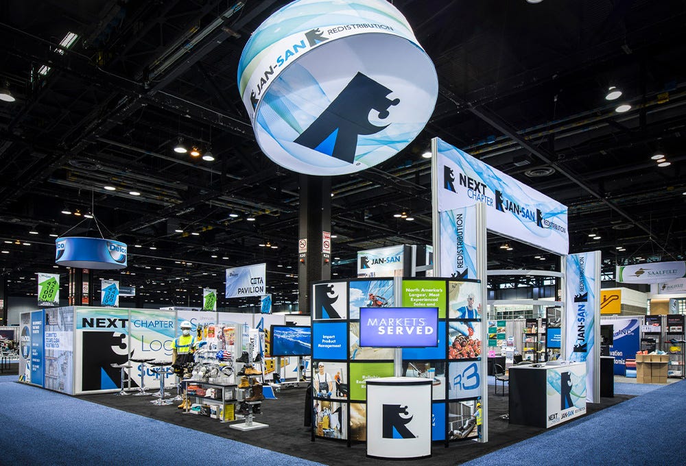 Large, island modular trade show exhibit with vibrant custom printed graphics