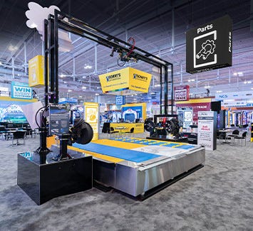 Large custom trade show booth featuring a car wash and meeting spaces